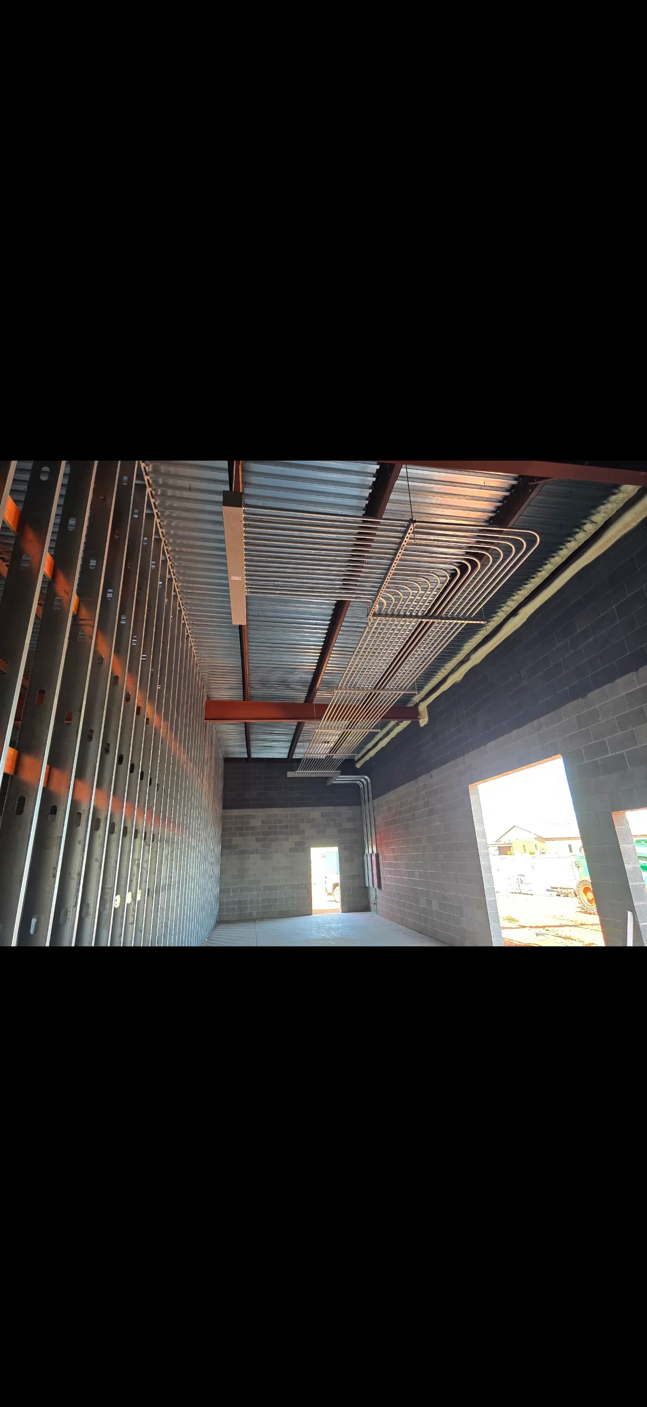 Commercial electrical rough-in with conduit runs, junction boxes, and metal ceiling framing
